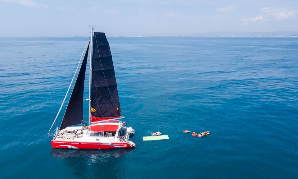 Barcelona: Sunset or Day Catamaran Cruise with Tapa & Drink - Marina Vela meeting point: easy access near Barceloneta and the W Hotel